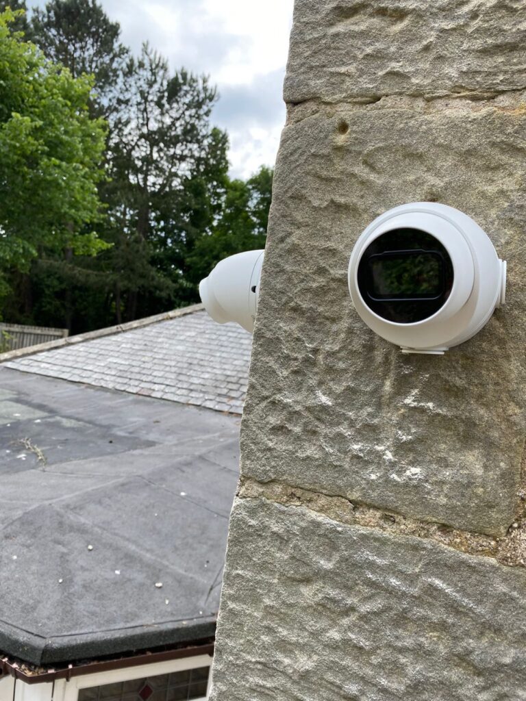 CCTV cameras mounted on a stone wall of a private home