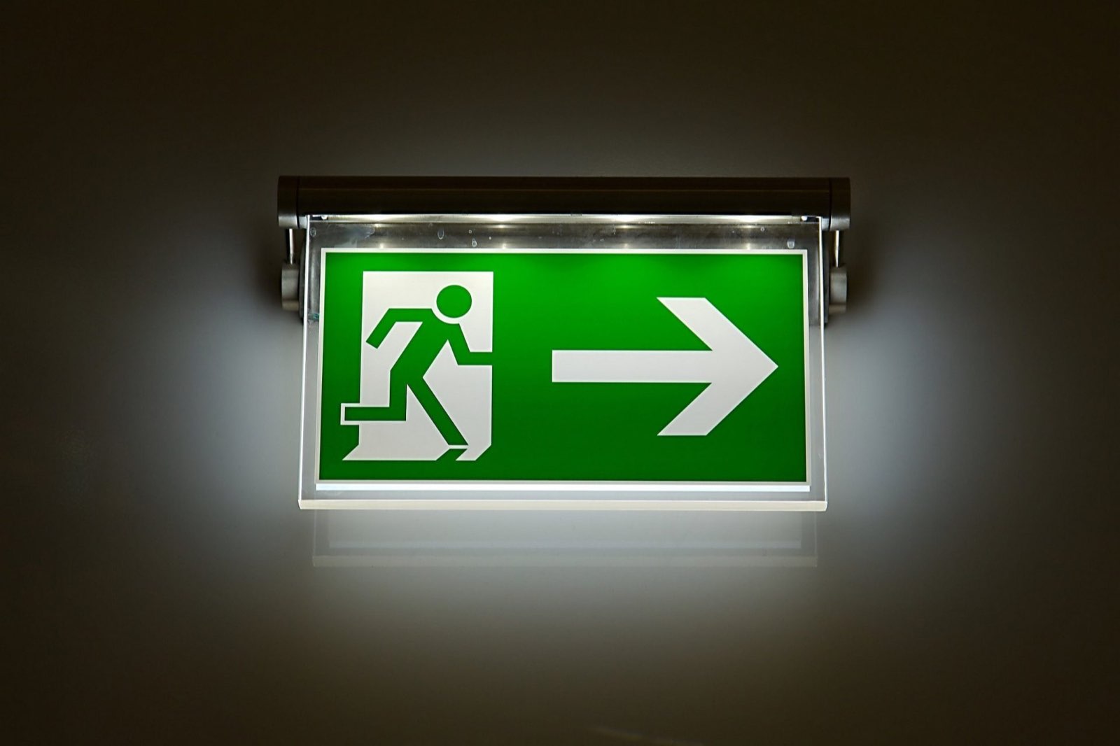 Illuminated green emergency exit sign