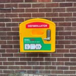 Image of defib on a red brick wall